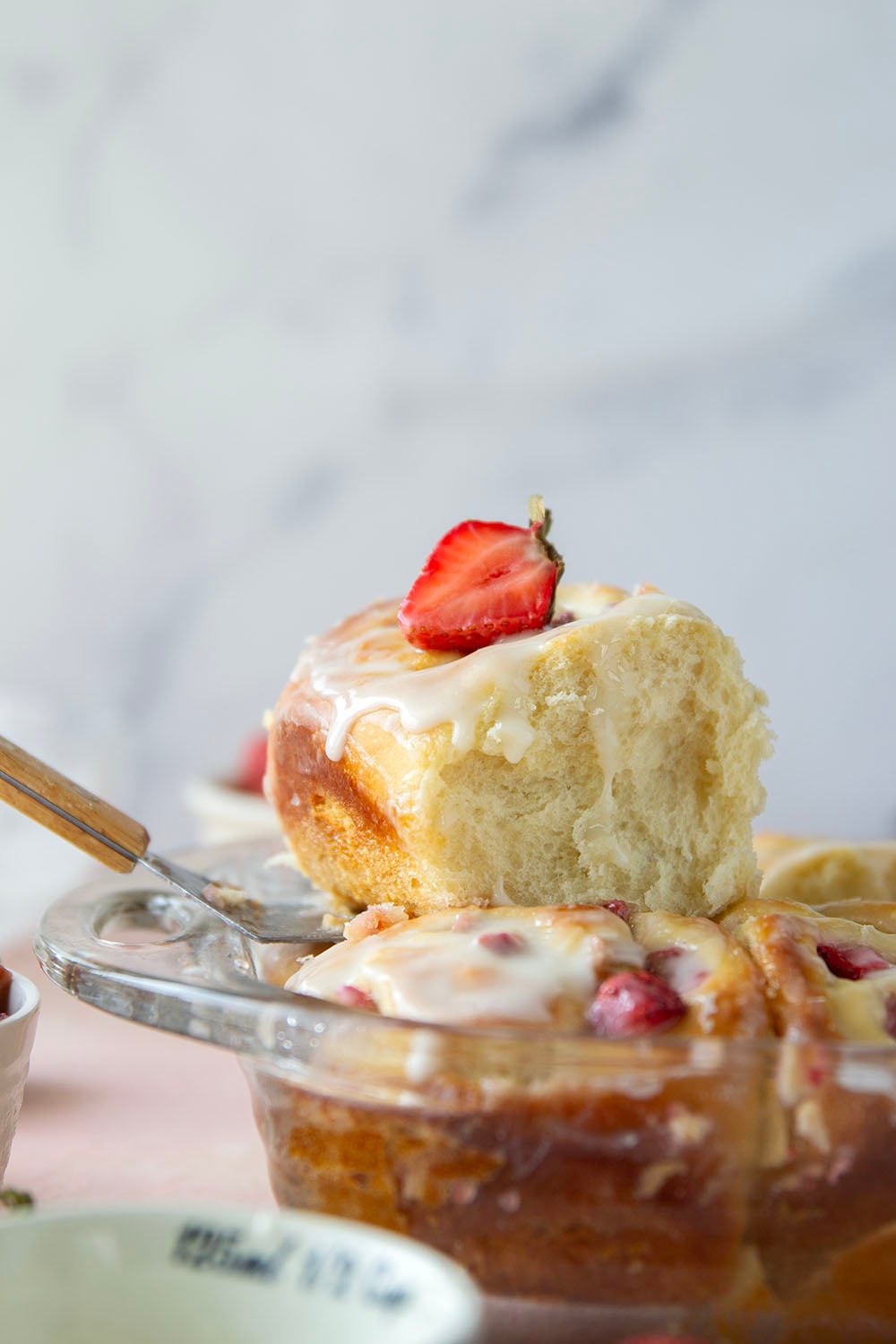 Melt-in-your-mouth fluffy sweet rolls are stuffed with a sweet and tangy rhubarb strawberry filling for the ultimate twist on strawberry sweet rolls!