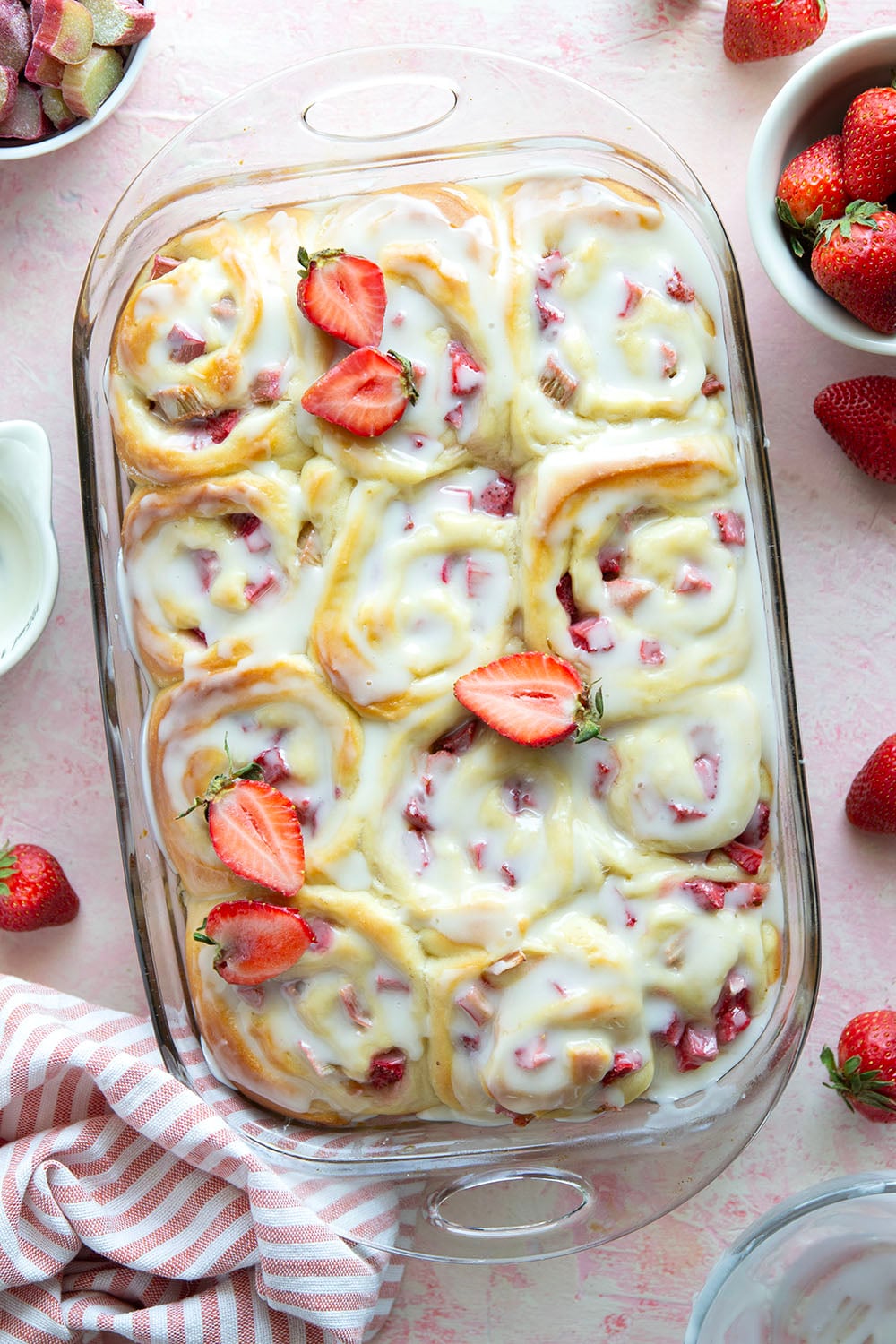 Melt-in-your-mouth fluffy sweet rolls are stuffed with a sweet and tangy rhubarb strawberry filling for the ultimate twist on strawberry sweet rolls!