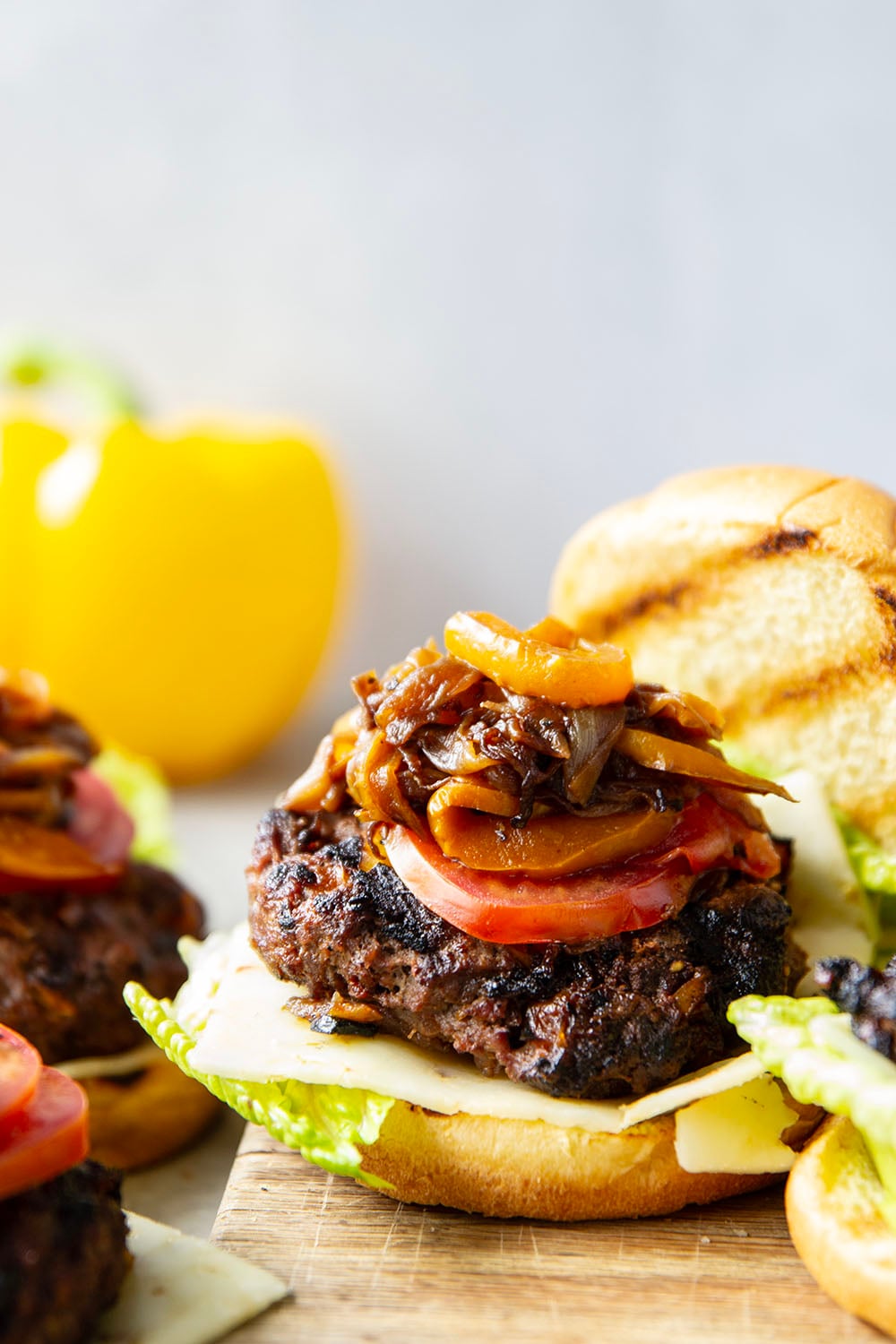 This juicy caramelized onion burger features caramelized onions and sweet peppers packed both inside the burger for extra flavor and more piled on top with a slice of pepperjack cheese and crisp lettuce.