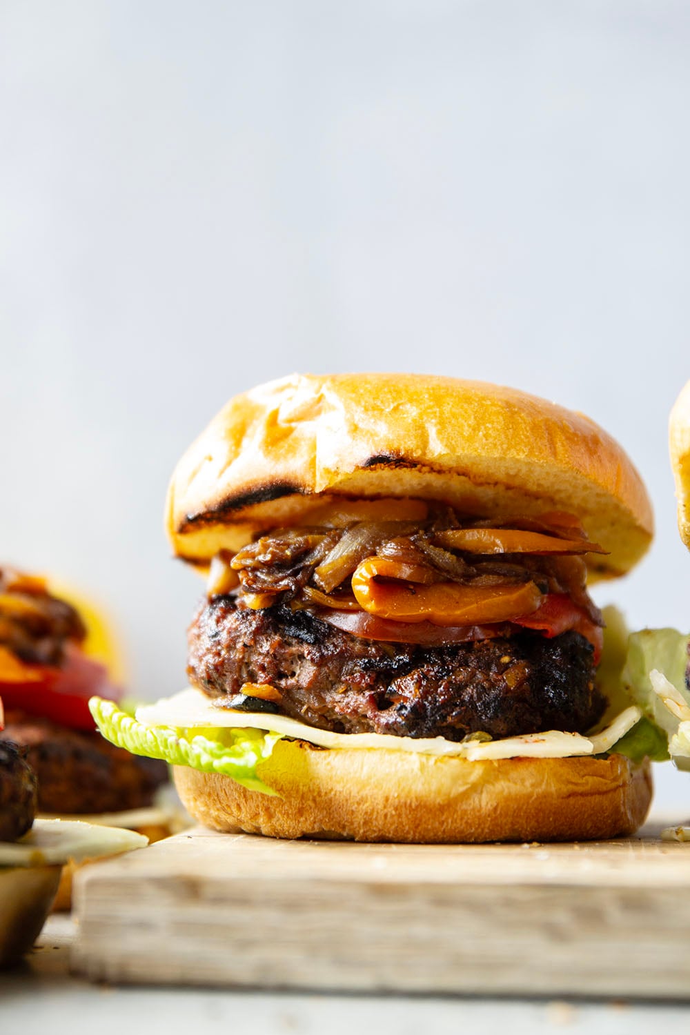 This juicy caramelized onion burger features caramelized onions and sweet peppers packed both inside the burger for extra flavor and more piled on top with a slice of pepperjack cheese and crisp lettuce.