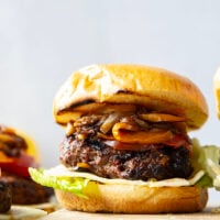 This juicy caramelized onion burger features caramelized onions and sweet peppers packed both inside the burger for extra flavor and more piled on top with a slice of pepperjack cheese and crisp lettuce.