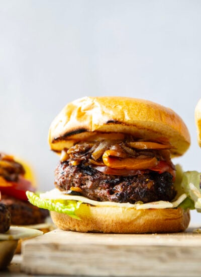 This juicy caramelized onion burger features caramelized onions and sweet peppers packed both inside the burger for extra flavor and more piled on top with a slice of pepperjack cheese and crisp lettuce.