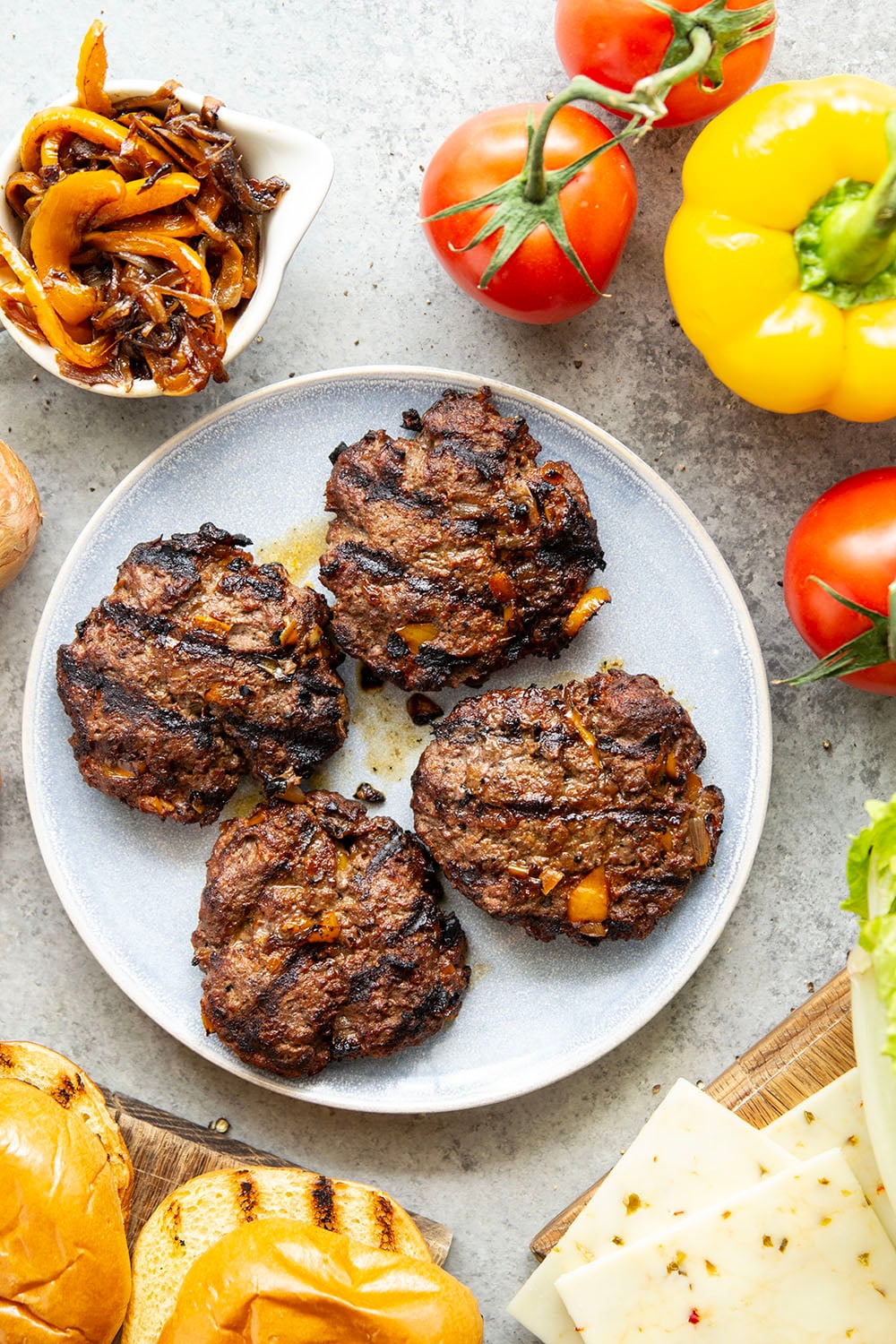 This juicy caramelized onion burger features caramelized onions and sweet peppers packed both inside the burger for extra flavor and more piled on top with a slice of pepperjack cheese and crisp lettuce.