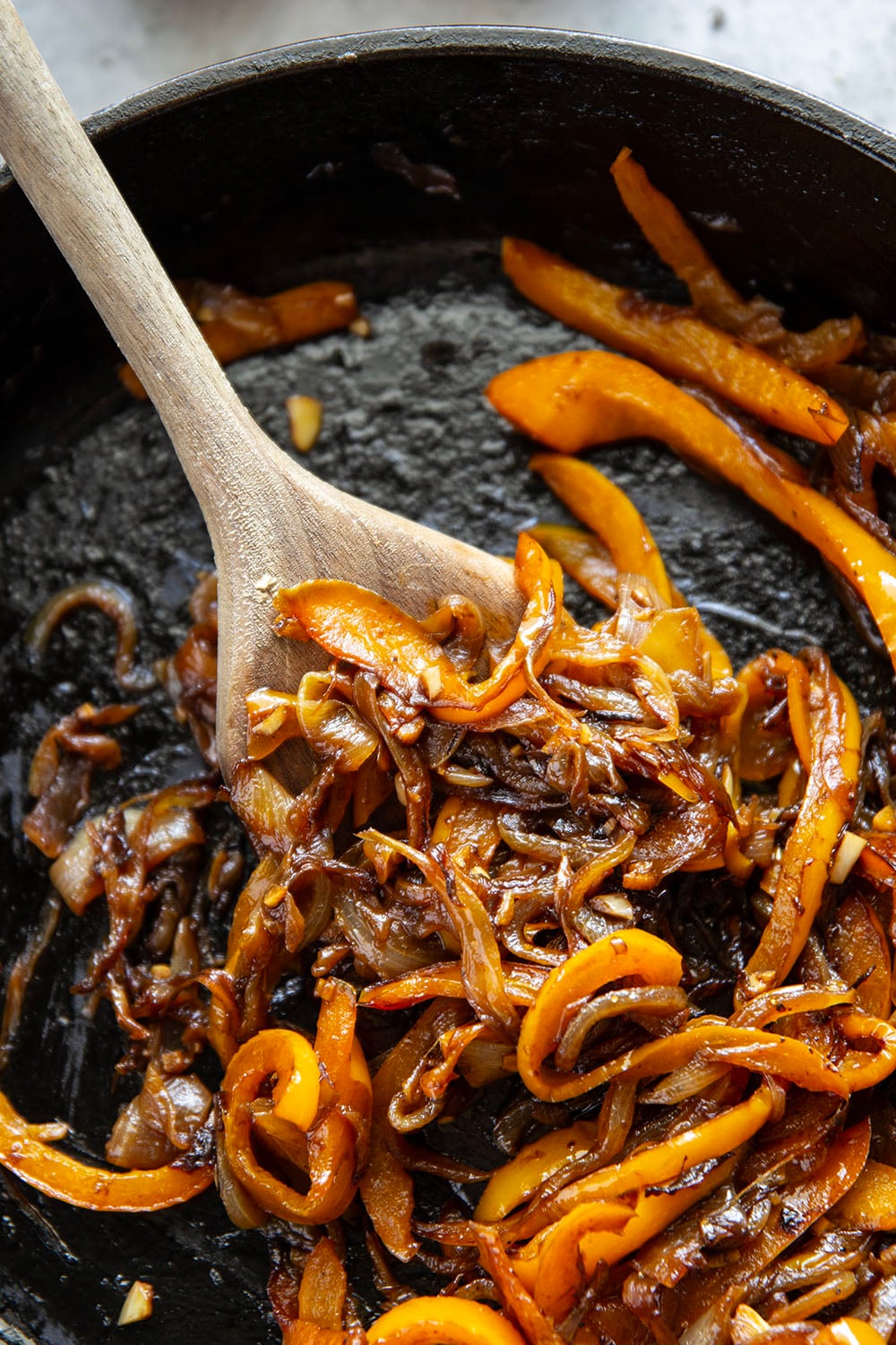 This juicy caramelized onion burger features caramelized onions and sweet peppers packed both inside the burger for extra flavor and more piled on top with a slice of pepperjack cheese and crisp lettuce.