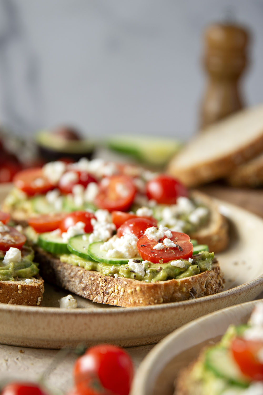 This Greek avocado toast is quick and easy enough for any kind of breakfast occasion! Pile toasted bread slices with silky mashed avocado, crisp cucumber slices, lots of fresh cherry tomatoes, and feta.