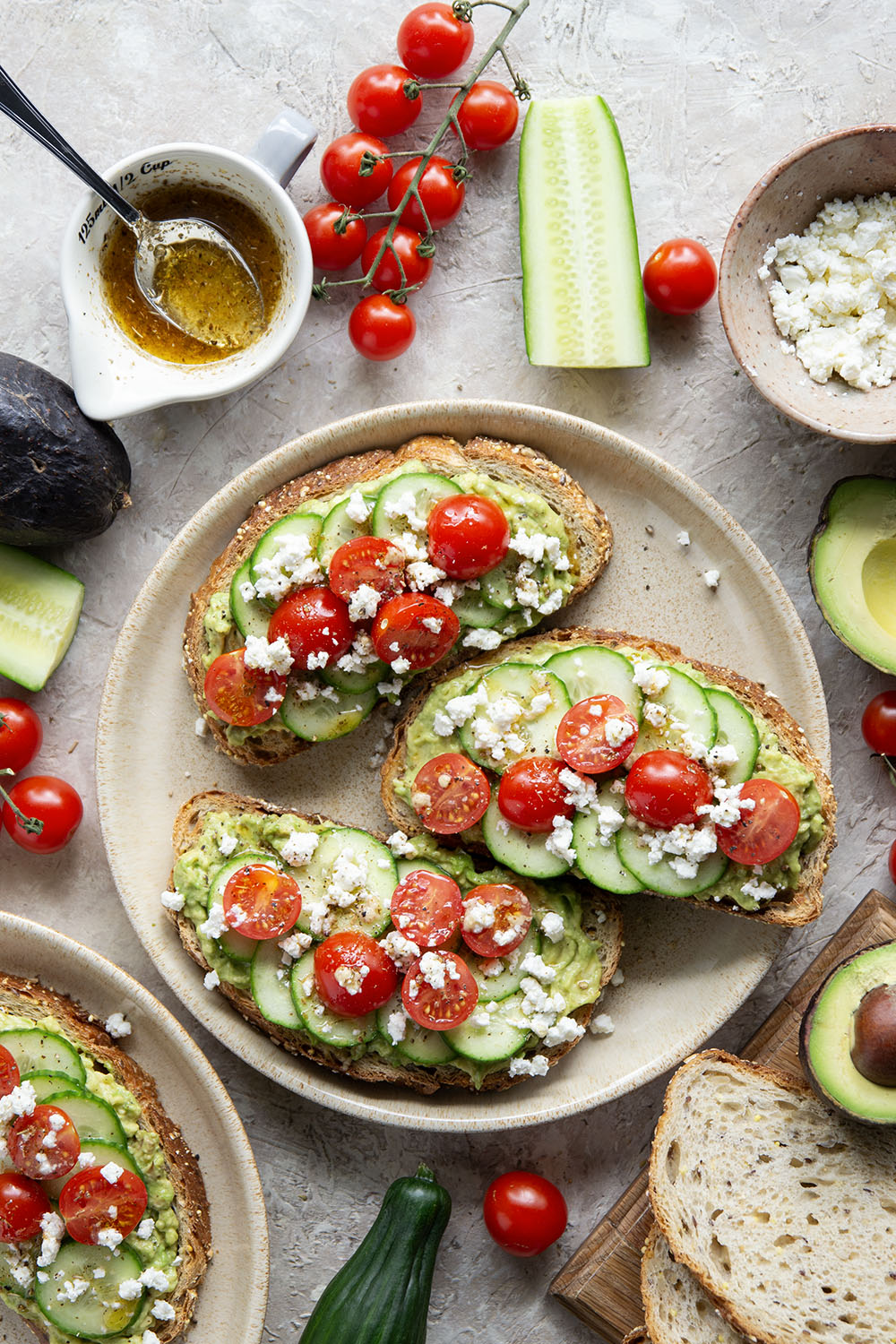 This Greek avocado toast is quick and easy enough for any kind of breakfast occasion! Pile toasted bread slices with silky mashed avocado, crisp cucumber slices, lots of fresh cherry tomatoes, and feta.