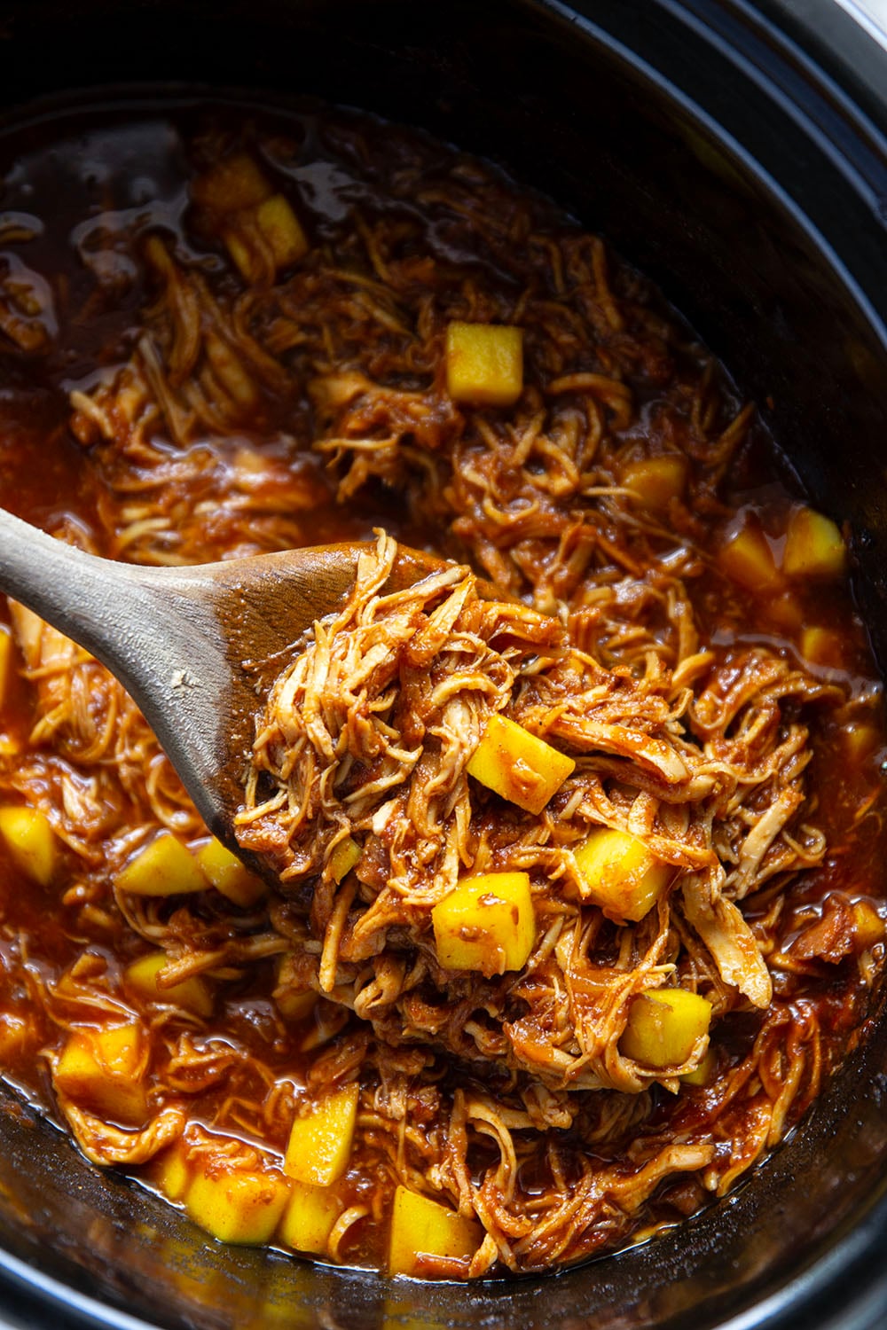 Slow cooked until perfectly fall-apart tender in lots of sweet mango and a homemade sauce, this pulled mango BBQ chicken makes the best summer sandwich with fresh slaw on top.
