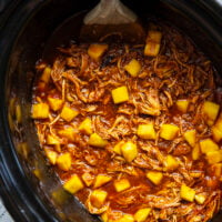 Slow cooked until perfectly fall-apart tender in lots of sweet mango and a homemade sauce, this pulled mango BBQ chicken makes the best summer sandwich with fresh slaw on top.