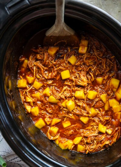 Slow cooked until perfectly fall-apart tender in lots of sweet mango and a homemade sauce, this pulled mango BBQ chicken makes the best summer sandwich with fresh slaw on top.