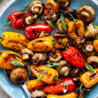A mix of mushrooms and mini sweet peppers are marinated for hours in a flavorful soy marinade, grilled until tender and smoky, and topped with lots of green onions for an easy summer veggie side dish.