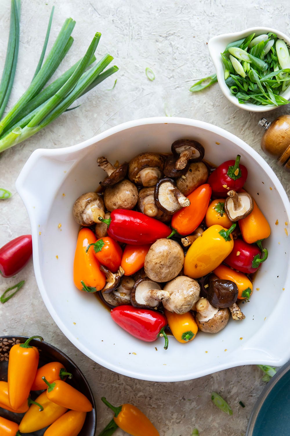 A mix of mushrooms and mini sweet peppers are marinated for hours in a flavorful soy marinade, grilled until tender and smoky, and topped with lots of green onions for an easy summer veggie side dish.