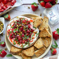 Silky whipped goat cheese is topped with juicy honey roasted strawberries and incredible served with crostini for dipping.