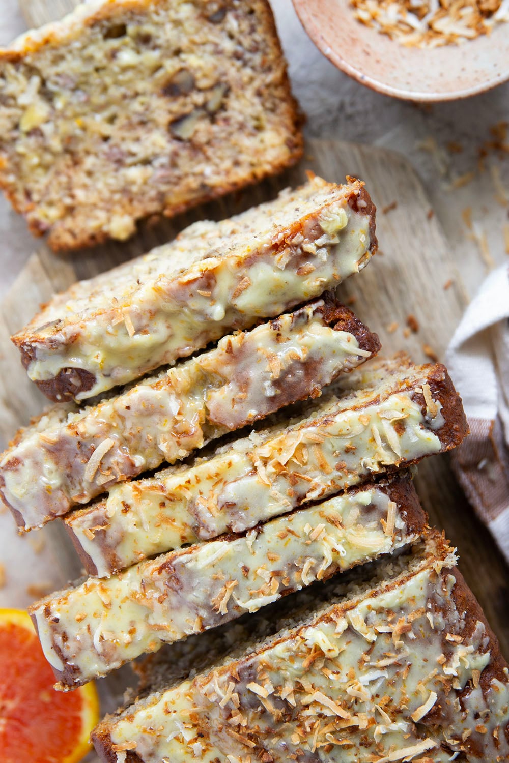 This tropical banana bread features a perfectly soft and dense texture and is packed with flaked coconut, lots of pineapple, and topped with a sweet citrus glaze.