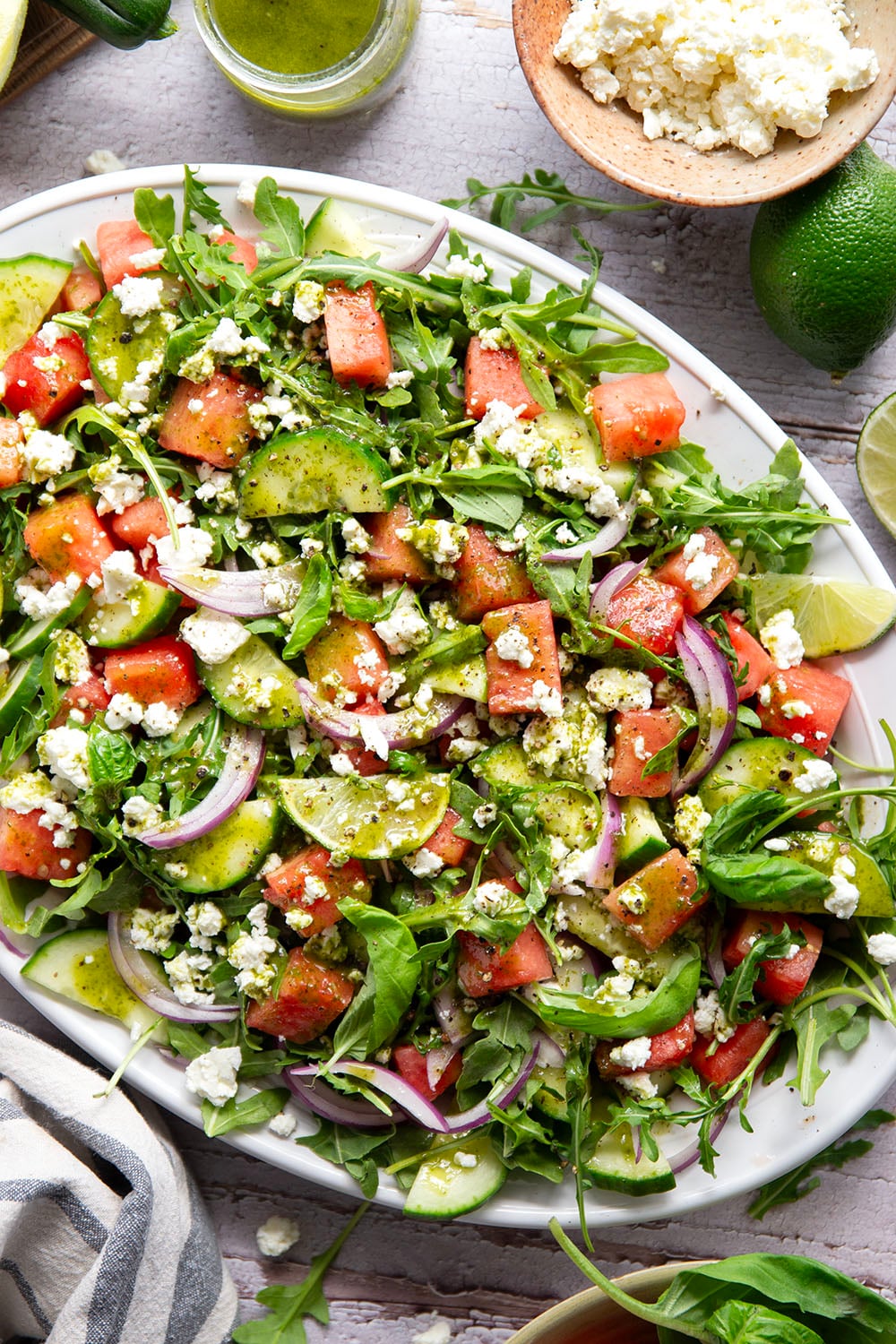 Sweet watermelon, tangy feta, and crisp cucumbers are the best salad combo in this watermelon feta cucumber salad that gets dressed in a fresh basil lime dressing and goes well with any summer meal.