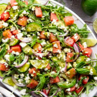 Sweet watermelon, tangy feta, and crisp cucumbers are the best salad combo in this watermelon feta cucumber salad that gets dressed in a fresh basil lime dressing and goes well with any summer meal.