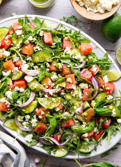Sweet watermelon, tangy feta, and crisp cucumbers are the best salad combo in this watermelon feta cucumber salad that gets dressed in a fresh basil lime dressing and goes well with any summer meal.