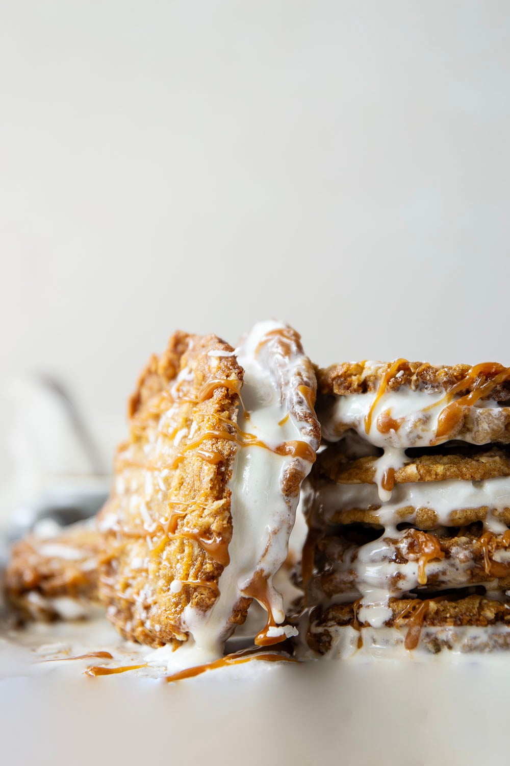 A base of crispy coconut cookies, homemade salted caramel, and a filling of creamy vanilla ice cream take these caramel ice cream sandwiches completely over the top!
