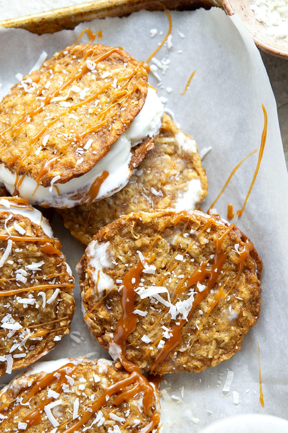 A base of crispy coconut cookies, homemade salted caramel, and a filling of creamy vanilla ice cream take these caramel ice cream sandwiches completely over the top!