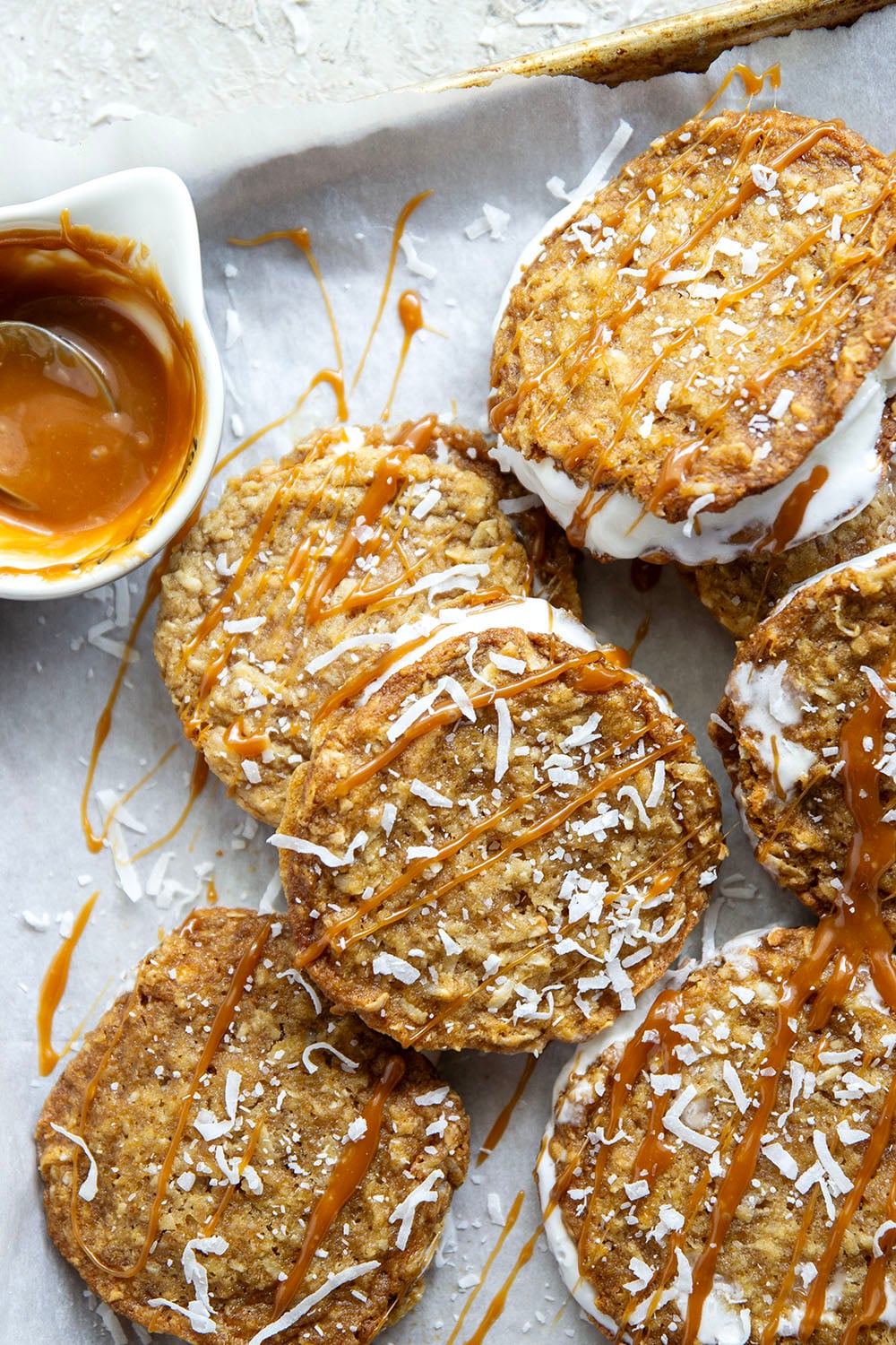 A base of crispy coconut cookies, homemade salted caramel, and a filling of creamy vanilla ice cream take these caramel ice cream sandwiches completely over the top!