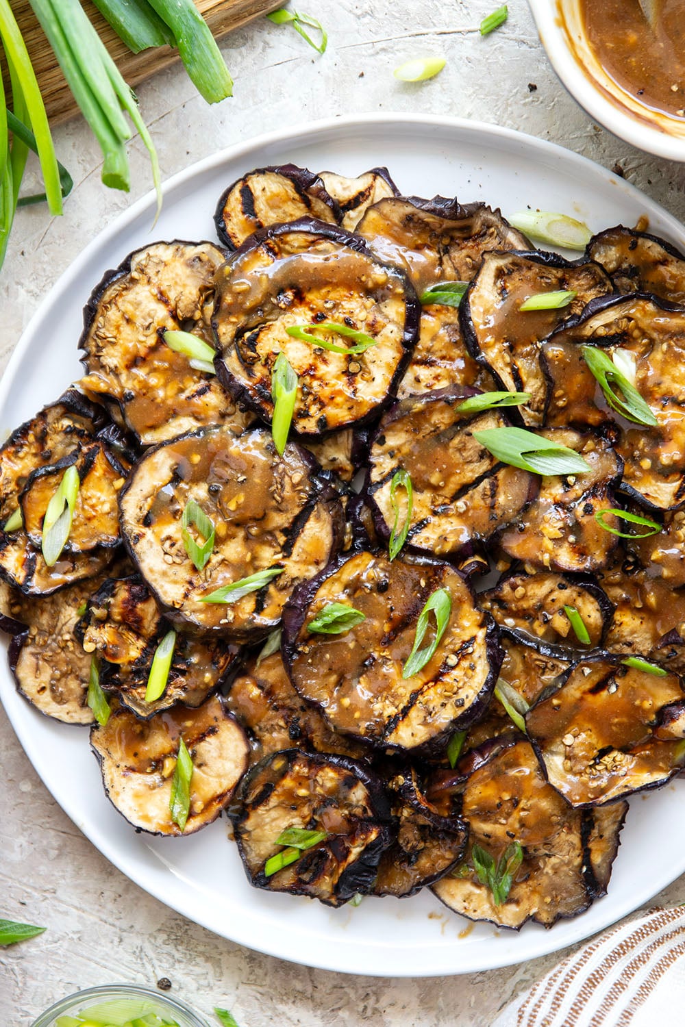 Grilled until crispy and drizzled in a flavorful miso ginger sauce, this miso grilled eggplant is the perfect way to use an abundance of eggplant and goes well with any Asian-inspired meal.
