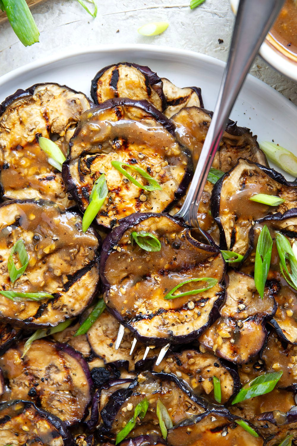 Grilled until crispy and drizzled in a flavorful miso ginger sauce, this miso grilled eggplant is the perfect way to use an abundance of eggplant and goes well with any Asian-inspired meal.