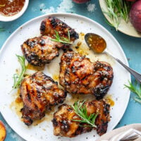 A sweet, jammy honey peach glaze coats every inch of juicy grilled chicken thighs in this peach glazed chicken that's incredible with fresh summer peaches.