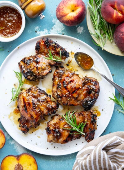 A sweet, jammy honey peach glaze coats every inch of juicy grilled chicken thighs in this peach glazed chicken that's incredible with fresh summer peaches.
