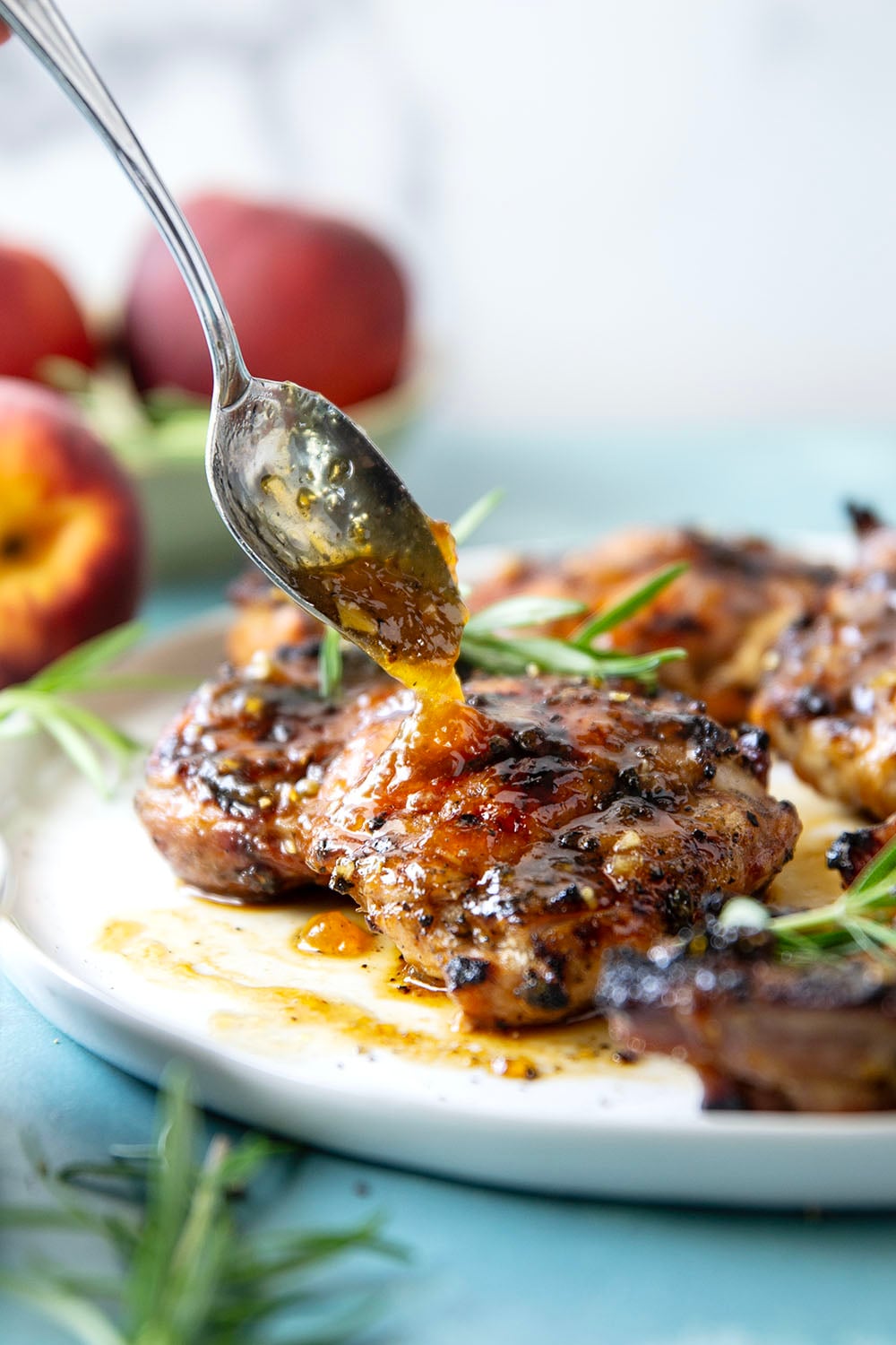 A sweet, jammy honey peach glaze coats every inch of juicy grilled chicken thighs in this peach glazed chicken that's incredible with fresh summer peaches.