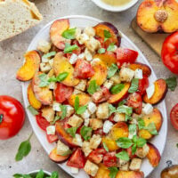This summery peach panzanella salad is loaded down with crisp toasted bread, juicy peach slices, sweet tomatoes, and lots of fresh basil. A flavorful shallot dressing drizzled on top adds so much flavor!