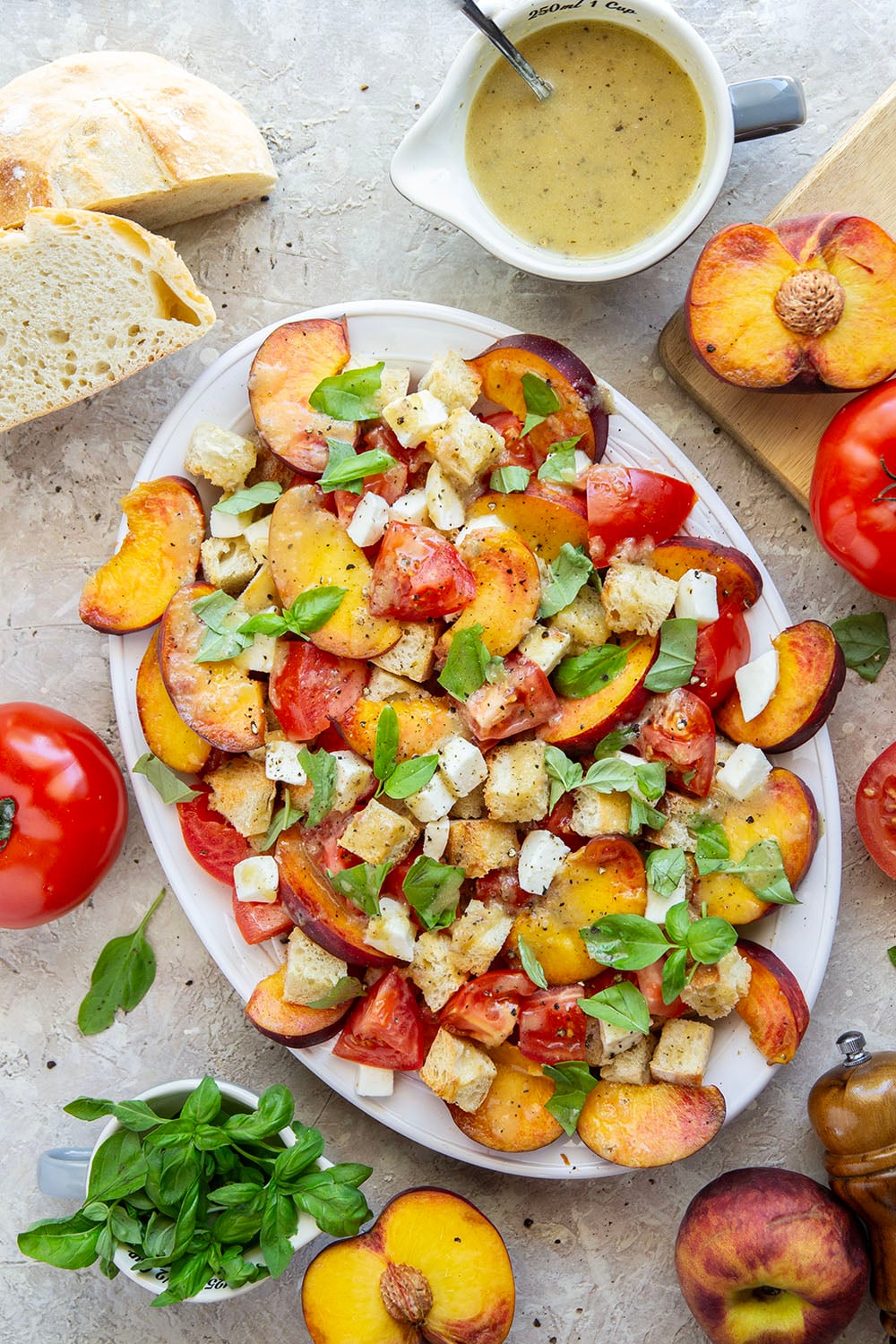 This summery peach panzanella salad is loaded down with crisp toasted bread, juicy peach slices, sweet tomatoes, and lots of fresh basil. A flavorful shallot dressing drizzled on top adds so much flavor!