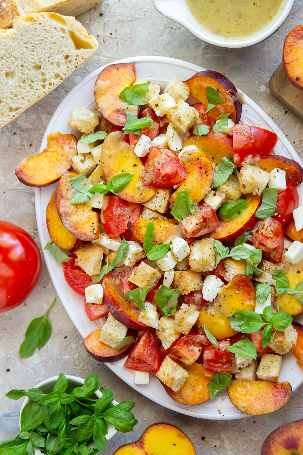 This summery peach panzanella salad is loaded down with crisp toasted bread, juicy peach slices, sweet tomatoes, and lots of fresh basil. A flavorful shallot dressing drizzled on top adds so much flavor!