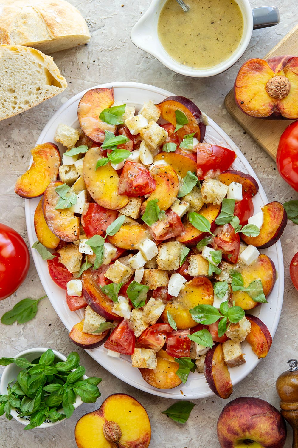 This summery peach panzanella salad is loaded down with crisp toasted bread, juicy peach slices, sweet tomatoes, and lots of fresh basil. A flavorful shallot dressing drizzled on top adds so much flavor!