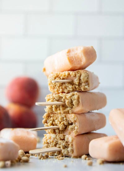 Juicy summer peaches and a crunchy brown sugar streusel are the perfect match in these multi-layered peach popsicles!
