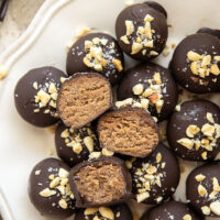These protein peanut butter balls take only a handful of ingredients to throw together and taste exactly like a peanut butter cup!