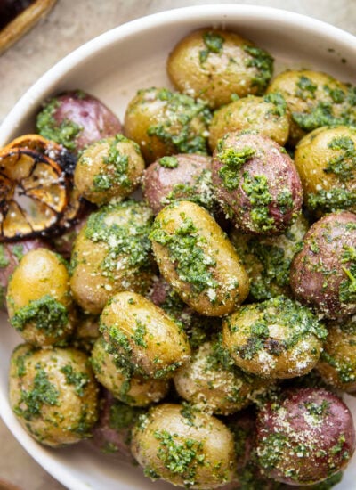 These pesto roasted potatoes feature tender, crispy roasted fingerling potatoes tossed in a homemade lemon kale pesto.