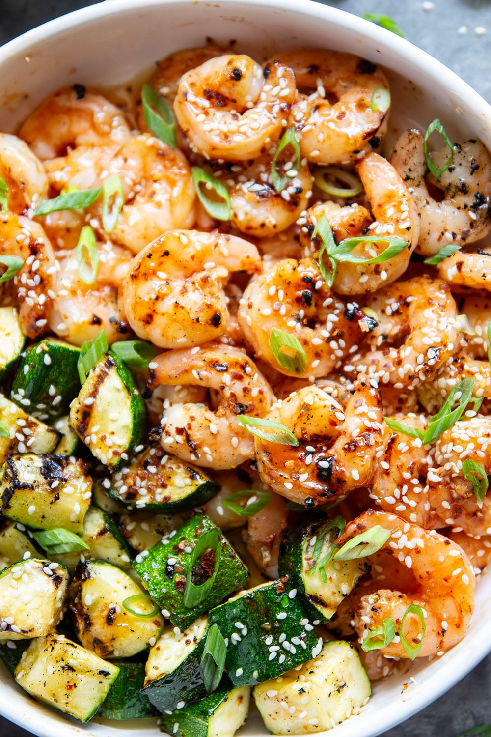 Grilled in spicy sweet chili sauce alongside tender zucchini cubes, this grilled sweet chili shrimp is a quick summer meal that's fantastic as an appetizer or served alongside rice.