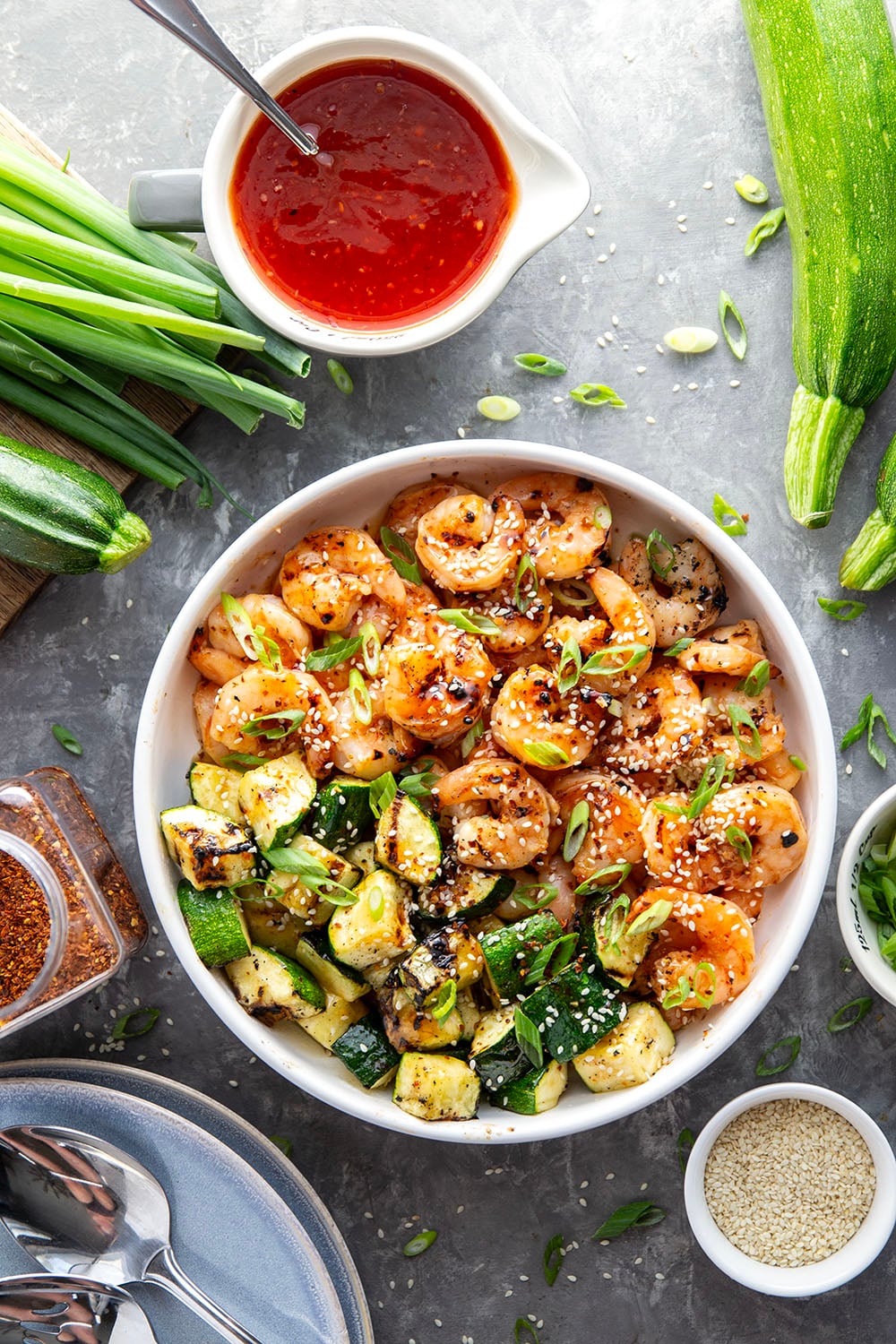 Grilled in spicy sweet chili sauce alongside tender zucchini cubes, this grilled sweet chili shrimp is a quick summer meal that's fantastic as an appetizer or served alongside rice.