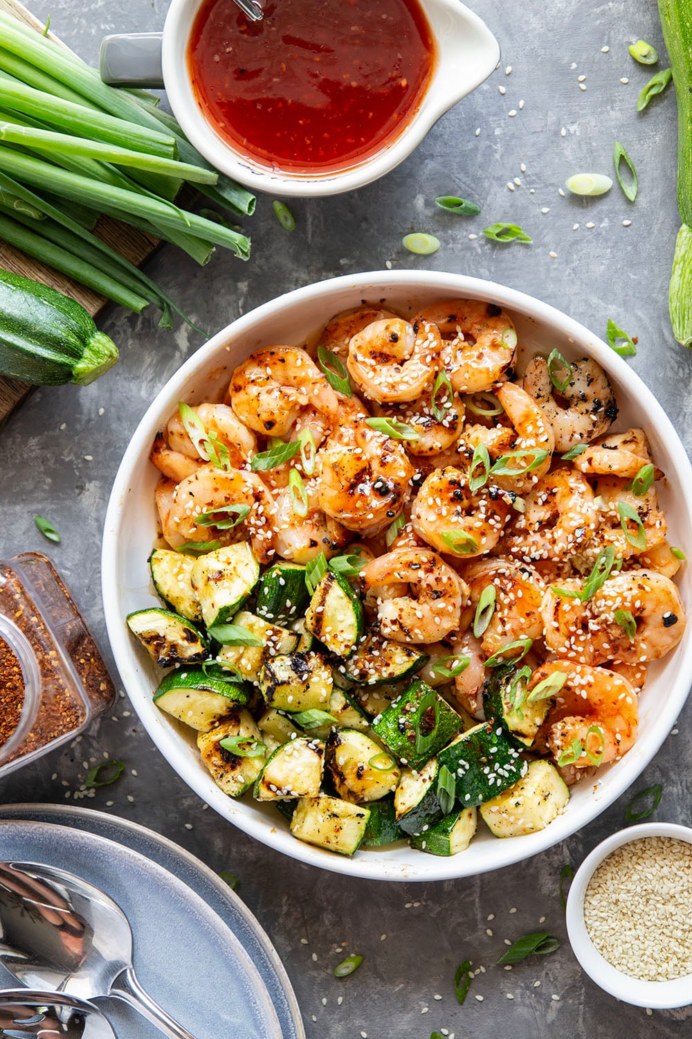 Grilled in spicy sweet chili sauce alongside tender zucchini cubes, this grilled sweet chili shrimp is a quick summer meal that's fantastic as an appetizer or served alongside rice.