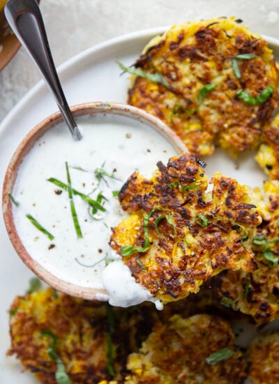 These yellow squash fritters feature perfectly crispy exteriors with a moist, flavorful texture inside. Serve them hot and crispy from the skillet with an herby fresh basil sour cream.