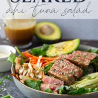 This seared ahi tuna salad features perfectly seared ahi tuna dressed up in bowls with lots of fresh greens, crunchy wonton strips, and a savory ginger soy dressing.
