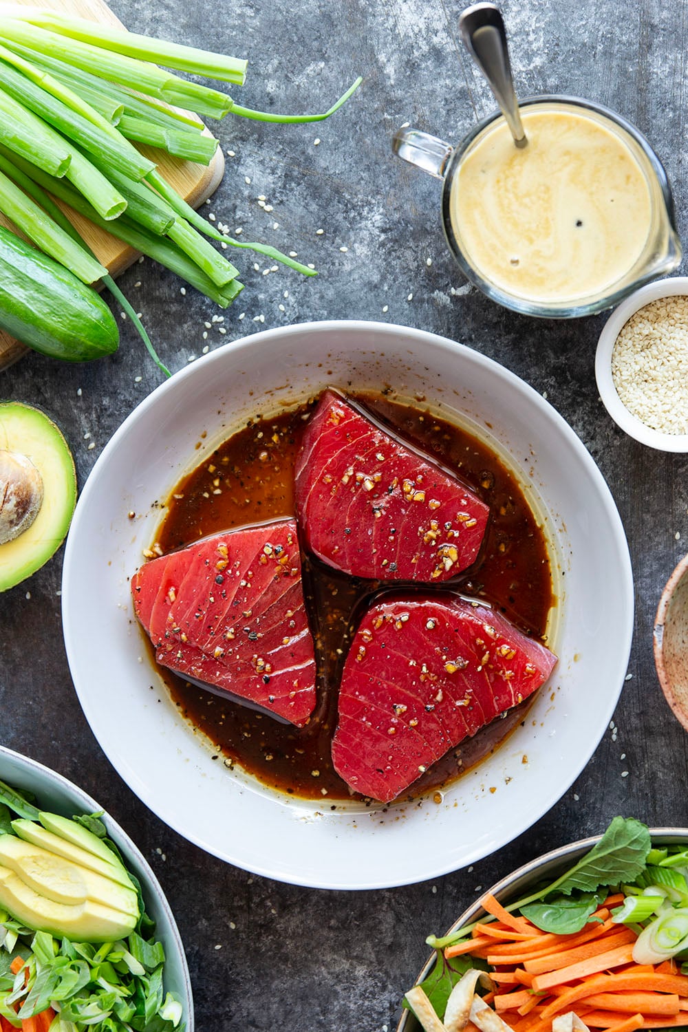 This seared ahi tuna salad features perfectly seared ahi tuna dressed up in bowls with lots of fresh greens, crunchy wonton strips, and a savory ginger soy dressing.