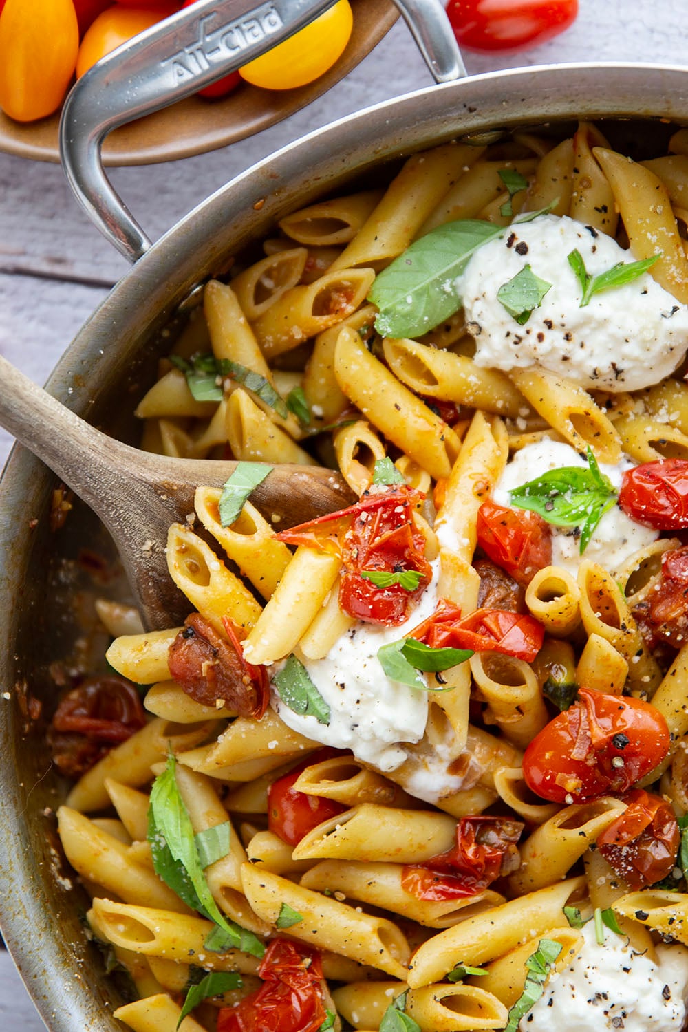 Garden-fresh burst tomato pasta features juicy cherry tomatoes cooked in flavorful white wine with lots of fresh garlic and basil.