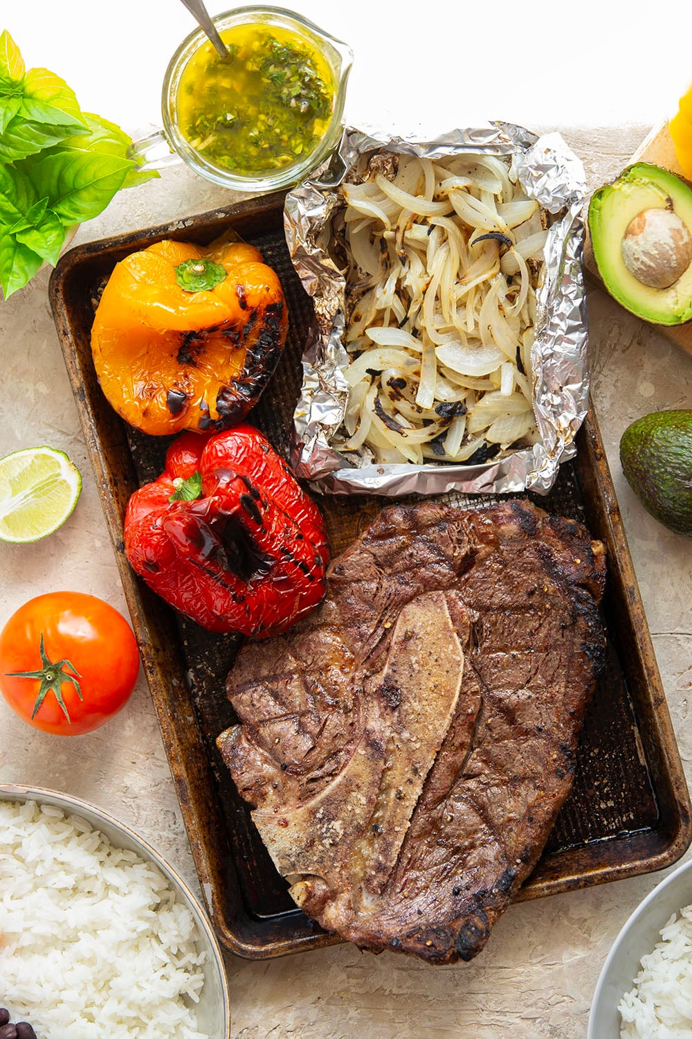 Juicy grilled sirloin steak, sweet peppers, and an herby fresh chimichurri sauce make for the ultimate summer steak fajita bowls.