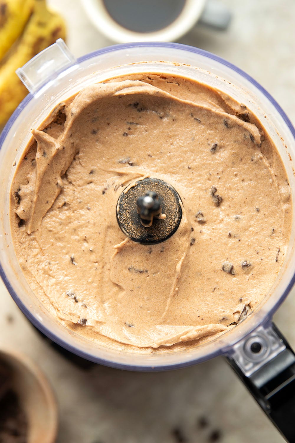 Rich brewed coffee and crunchy chocolate pieces star in this creamy coffee banana ice cream that's entirely banana-based and doesn't even require an ice cream maker!