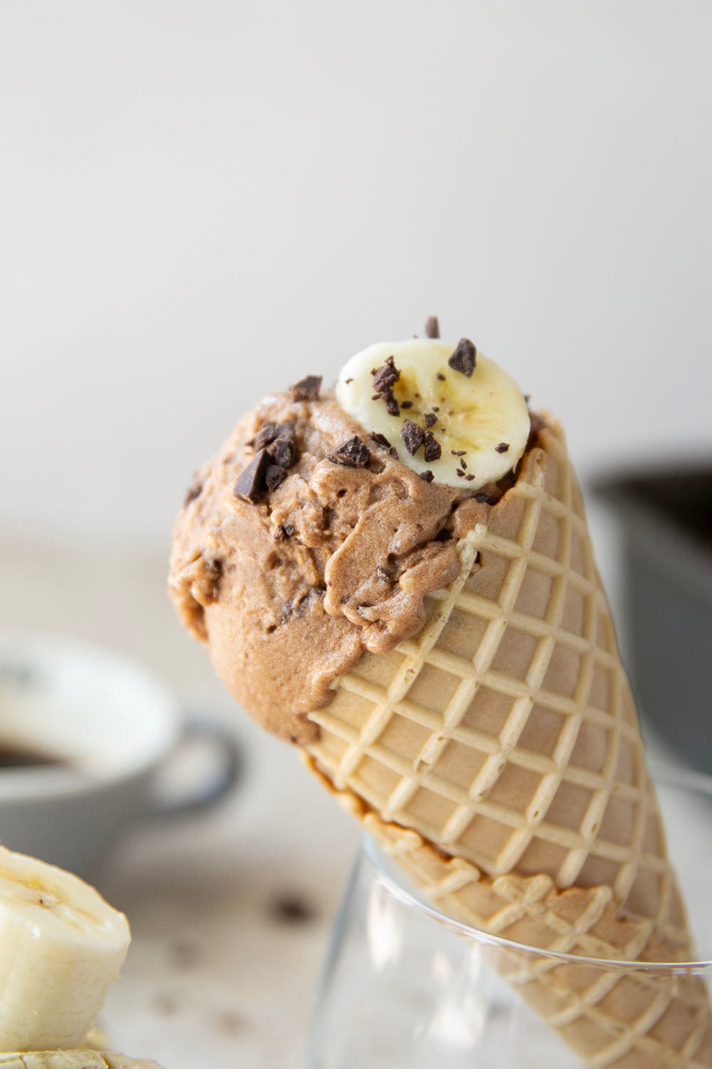 Rich brewed coffee and crunchy chocolate pieces star in this creamy coffee banana ice cream that's entirely banana-based and doesn't even require an ice cream maker!