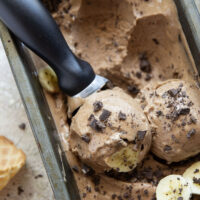 Rich brewed coffee and crunchy chocolate pieces star in this creamy coffee banana ice cream that's entirely banana-based and doesn't even require an ice cream maker!