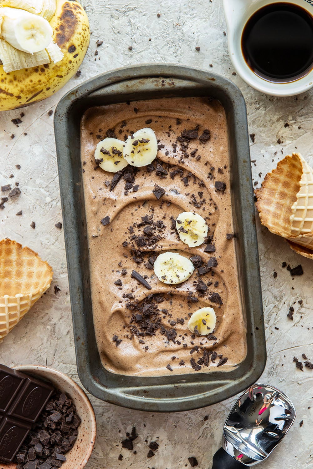 Rich brewed coffee and crunchy chocolate pieces star in this creamy coffee banana ice cream that's entirely banana-based and doesn't even require an ice cream maker!