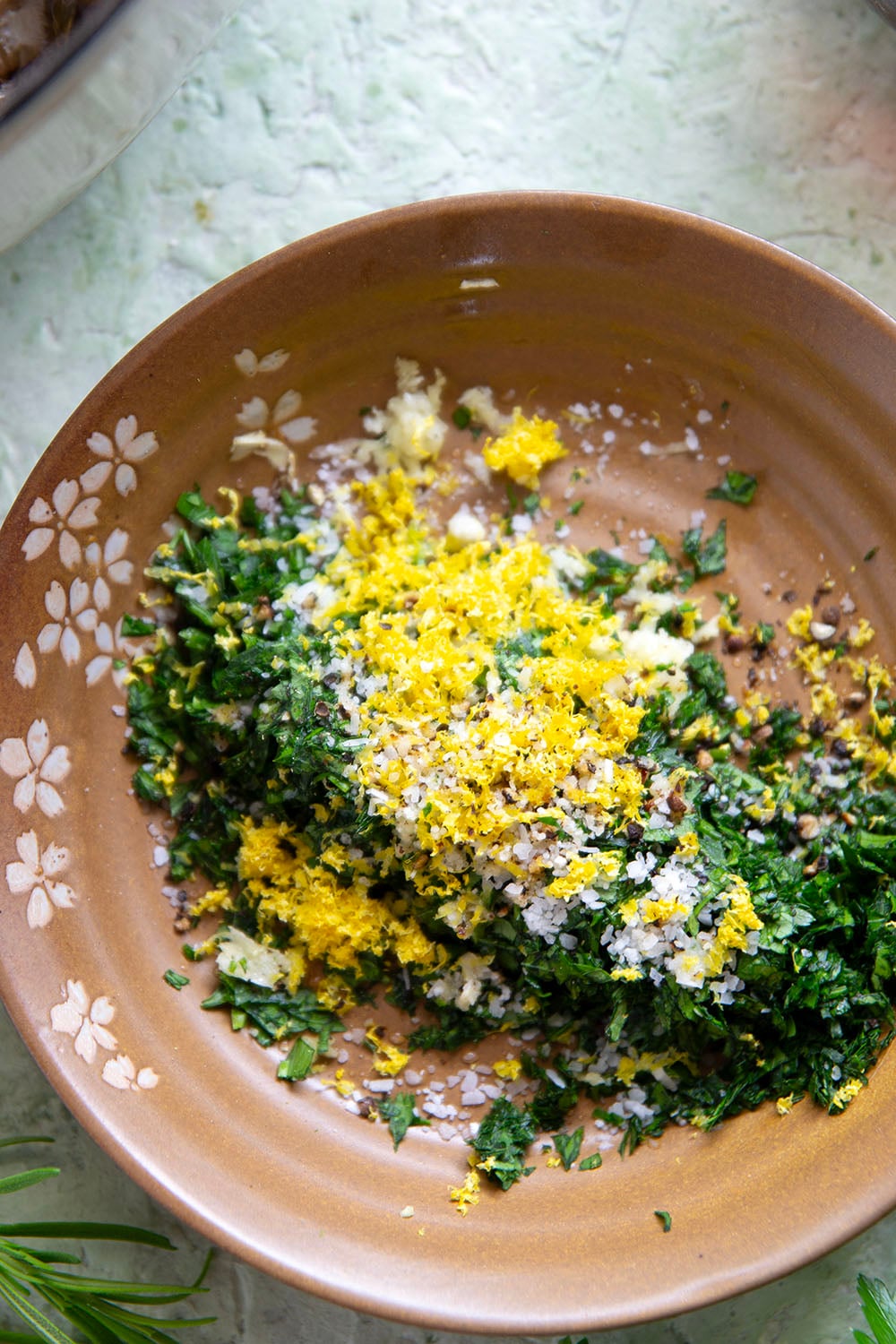 Fall-apart tender beef short ribs with gremolata feature red wine-braised short ribs cooked for hours until tender and topped with a fresh, herby gremolata topping.