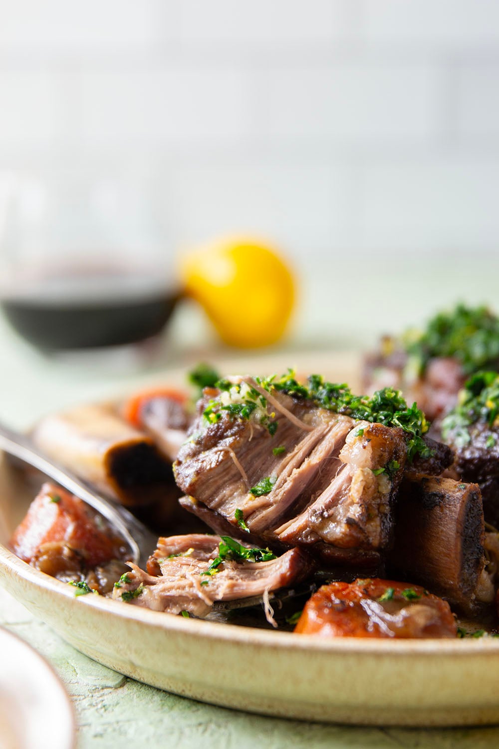 Fall-apart tender beef short ribs with gremolata feature red wine-braised short ribs cooked for hours until tender and topped with a fresh, herby gremolata topping.