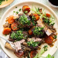 Fall-apart tender beef short ribs with gremolata feature red wine-braised short ribs cooked for hours until tender and topped with a fresh, herby gremolata topping.
